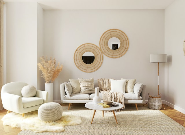 Cozy living room with a fluffy white chair, light grey couch, and multiple rugs